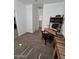 Bedroom showcasing a functional desk area, closet, and a comfortable carpet at 11959 W Pierce St, Avondale, AZ 85323