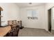 Bedroom with a desk, soft carpet, and natural light offers a perfect space for work or study at 11959 W Pierce St, Avondale, AZ 85323