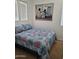 This bedroom has carpet, a patterned bedspread, and natural light from the windows at 11959 W Pierce St, Avondale, AZ 85323