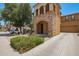 Attractive two-story home with a stone facade, balcony, covered porch, and desert landscaping at 11959 W Pierce St, Avondale, AZ 85323