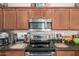 Close-up of the kitchen with stainless steel oven and dark wood cabinets at 11959 W Pierce St, Avondale, AZ 85323