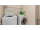 Practical laundry room with front-load washer and dryer and overhead shelving at 11959 W Pierce St, Avondale, AZ 85323