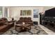Inviting living room with a leather sofa set, modern furnishings, and neutral décor at 11959 W Pierce St, Avondale, AZ 85323