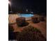 Night shot of the community pool and landscaping, fenced for safety at 11959 W Pierce St, Avondale, AZ 85323