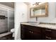Bathroom with granite counter, wooden cabinets, vessel sink and tiled walk-in shower at 1234 N 84Th Pl, Scottsdale, AZ 85257