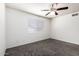 Bright bedroom features neutral walls, gray carpet flooring, and a sunny window at 1234 N 84Th Pl, Scottsdale, AZ 85257