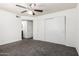 Bright bedroom featuring neutral walls, ceiling fan, closet and gray carpet flooring at 1234 N 84Th Pl, Scottsdale, AZ 85257
