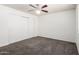 Bright bedroom features neutral walls, ceiling fan, closet and gray carpet flooring at 1234 N 84Th Pl, Scottsdale, AZ 85257