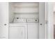 Laundry room featuring white washer and dryer with shelving and white walls at 1234 N 84Th Pl, Scottsdale, AZ 85257