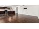 Spacious open-concept living room with dark laminate flooring, seamlessly connecting to the modern kitchen for easy entertaining at 1234 N 84Th Pl, Scottsdale, AZ 85257