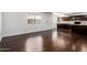 Stylish living room with dark laminate flooring, leading to a modern kitchen, offering a sleek and functional living space at 1234 N 84Th Pl, Scottsdale, AZ 85257