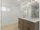 Bathroom featuring double vanity, wooden cabinets, and marble style tile in the shower at 126 E Northern Ave, Phoenix, AZ 85020