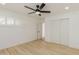 Bright bedroom with a ceiling fan, plantation shutters, and wide-plank flooring at 126 E Northern Ave, Phoenix, AZ 85020