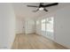 Bedroom with a ceiling fan, sliding glass doors, and wide-plank flooring at 126 E Northern Ave, Phoenix, AZ 85020