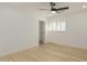 Bright bedroom with a ceiling fan, plantation shutters, and wide-plank flooring at 126 E Northern Ave, Phoenix, AZ 85020
