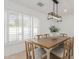 Sunlit dining room featuring a modern light fixture and large window at 126 E Northern Ave, Phoenix, AZ 85020