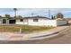 Corner lot home with modern black and white exterior paint scheme and mature palm trees at 126 E Northern Ave, Phoenix, AZ 85020