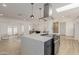 Open concept kitchen with a large island, pendant lighting, stainless hood and view to the living area at 126 E Northern Ave, Phoenix, AZ 85020