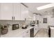 Bright, modern kitchen with white cabinets, stainless steel appliances, and stylish backsplash at 126 E Northern Ave, Phoenix, AZ 85020