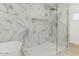 This modern shower space has marble-style tiling, gold accents, and a clear glass door at 126 E Northern Ave, Phoenix, AZ 85020