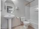 Bathroom featuring a pedestal sink, toilet, and a shower-tub combination at 134 W Campbell Ct, Gilbert, AZ 85233