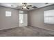 This large, bright bedroom boasts neutral carpeting and access to the second floor at 134 W Campbell Ct, Gilbert, AZ 85233