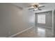 Neutral bedroom with tile flooring, a ceiling fan, and a window offering natural light at 134 W Campbell Ct, Gilbert, AZ 85233