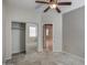Bright, carpeted bedroom features closet, ceiling fan, and natural light at 134 W Campbell Ct, Gilbert, AZ 85233