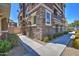 Corner townhouse featuring stone accents, manicured shrubs, and a sidewalk at 134 W Campbell Ct, Gilbert, AZ 85233
