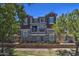 Charming multi-story townhouse featuring stone accents, multiple windows, and mature landscaping at 134 W Campbell Ct, Gilbert, AZ 85233