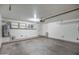 Spacious garage with a water heater, overhead lighting, and ample storage shelving at 134 W Campbell Ct, Gilbert, AZ 85233