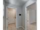 Hallway featuring tile flooring, doors to the laundry room and a bathroom at 134 W Campbell Ct, Gilbert, AZ 85233