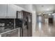 Modern kitchen with stainless steel appliances and tiled floors opening to living space at 134 W Campbell Ct, Gilbert, AZ 85233