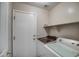 Laundry room featuring a washing machine, dryer, and shelving at 134 W Campbell Ct, Gilbert, AZ 85233