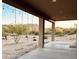 Relaxing back porch with hanging swings and a view of the natural desert landscape at 13819 E Cavalry Dr, Scottsdale, AZ 85262