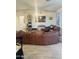 Spacious living area with modern furnishings, wood-look floors, and a large TV at 13819 E Cavalry Dr, Scottsdale, AZ 85262