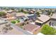 Aerial view of fenced yard with gravel landscaping, green turf and covered patio at 1384 S 222Nd Ln, Buckeye, AZ 85326