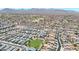 Aerial view of a community with a road leading to a commercial area, showcasing a mix of residential and retail spaces at 1384 S 222Nd Ln, Buckeye, AZ 85326