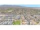 A stunning aerial view of a vast residential area surrounded by mountains and desert landscape, showcasing a well-planned community at 1384 S 222Nd Ln, Buckeye, AZ 85326