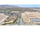 Expansive aerial view showcasing commercial development near residential areas, highlighting accessibility and community growth with mountain views at 1384 S 222Nd Ln, Buckeye, AZ 85326