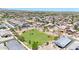 An aerial view of a well-planned neighborhood, featuring homes with solar panels and a large community green space at 1384 S 222Nd Ln, Buckeye, AZ 85326