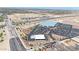 A high aerial view showing a highway with a big retail shopping area that has lots of parking spots and new construction at 1384 S 222Nd Ln, Buckeye, AZ 85326