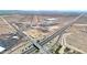 An aerial shot highlights the community's proximity to industrial and commercial hubs and convenient highway access at 1384 S 222Nd Ln, Buckeye, AZ 85326