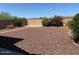 Spacious backyard with low maintenance landscaping, decorative gravel, and block fence surround at 1384 S 222Nd Ln, Buckeye, AZ 85326