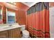 A bright bathroom featuring a sink, vanity and decorative shower curtain at 1384 S 222Nd Ln, Buckeye, AZ 85326