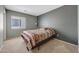 Neutral bedroom with a window provides natural light, with carpet flooring at 1384 S 222Nd Ln, Buckeye, AZ 85326
