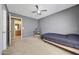 Well-lit bedroom featuring carpet flooring and a desk with a neutral color palette at 1384 S 222Nd Ln, Buckeye, AZ 85326