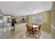 Bright dining area with a wooden table and views into the kitchen, creating a welcoming space for Gathering meals at 1384 S 222Nd Ln, Buckeye, AZ 85326