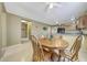 Bright dining area with a wooden table and views into the kitchen, creating a welcoming space for Gathering meals at 1384 S 222Nd Ln, Buckeye, AZ 85326