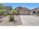 Charming single-story home featuring desert landscaping, a two-car garage, and a welcoming facade at 1384 S 222Nd Ln, Buckeye, AZ 85326